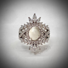 Load image into Gallery viewer, 7x9mm Breast Milk Keepsake Ring with Large Breast Milk “Stone” in a Halo and Infinity Band of Cubic Zirconia with Stacking Bands