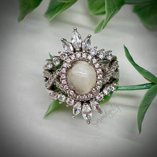 Load image into Gallery viewer, 7x9mm Breast Milk Keepsake Ring with Large Breast Milk “Stone” in a Halo and Infinity Band of Cubic Zirconia with Stacking Bands