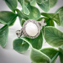 Load image into Gallery viewer, 7x9mm Breast Milk Keepsake Ring with Large Breast Milk “Stone” in a Halo and Infinity Band of Cubic Zirconia