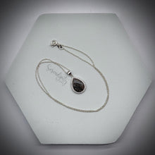 Load image into Gallery viewer, Sterling Silver Flat Tear Drop Cremation Ash Pendant with a Cubic Zirconia Halo