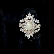 Load image into Gallery viewer, 7x9mm Breast Milk Keepsake Ring with Large Breast Milk “Stone” in a Halo and Infinity Band of Cubic Zirconia with Stacking Bands