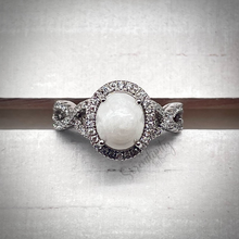 Load image into Gallery viewer, 7x9mm Breast Milk Keepsake Ring with Large Breast Milk “Stone” in a Halo and Infinity Band of Cubic Zirconia