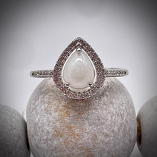 Load image into Gallery viewer, Breast Milk Keepsake Ring with 6x8mm Teardrop Breast Milk “Stone” in a Halo of Cubic Zirconia
