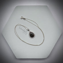 Load image into Gallery viewer, Sterling Silver Flat Tear Drop Cremation Ash Pendant with a Cubic Zirconia Halo
